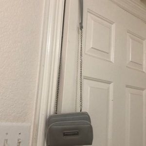 Small silver purse with chain strap.